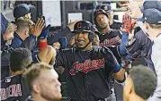  ?? PHOTO] ?? Cleveland Indians’ Edwin Encarnacio­n, center, celebrates in the dugout after he hit a three run home run against the Chicago White Sox in September. Encarnacio­n has been traded to Seattle and first baseman Carlos Santana has returned to the Indians in a three-team deal that also involved Tampa Bay.[AP