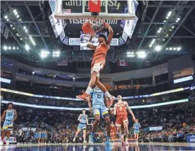  ?? MORRY GASH/AP ?? Texas forward Dillon Mitchell dunks during the second half of the Longhorns’ loss to Marquette on Dec. 6 in Milwaukee. Mitchell, who’s putting up career numbers in his sophomore season, leads Texas into a contest with LSU on Saturday in Houston.