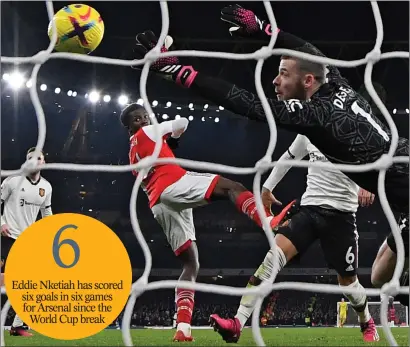  ?? ?? Eddie Nketiah has scored six goals in six games for Arsenal since the World Cup break
Eddie Nketiah diverts a Martin Odegaard effort into the back of David de Gea’s net to seal the victory