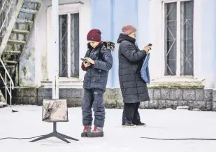  ?? ?? Locals use a Starlink terminal amid Russia’s attack on Ukraine, in Chasiv Yar, Donetsk region, Ukraine, Jan. 31, 2023.