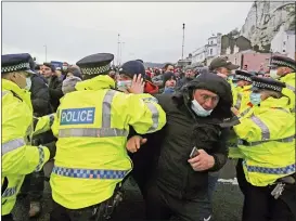  ?? STEVE PARSONS — PA VIA AP ?? Truck drivers argue with police holding them back at the entrance to the Port of Dover, in Kent, England, Wednesday Dec. 23, 2020.