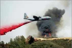  ?? NOAH BERGER — THE ASSOCIATED PRESS ?? An air tanker drops retardant on the River Fire burning near Lakeport on Tuesday.