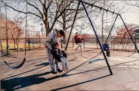  ?? Janice Chung / The New York Times ?? Children play Saturday at the Mary Whalen Playground in Queens. New Yorkers are conflicted by the lack of snow; they don’t miss the hassles of cleaning it up but they do miss the opportunit­ies it offers for recreation.