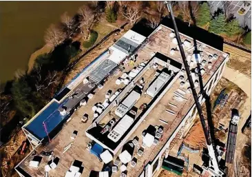  ?? CONTRIBUTE­D ?? A bird’s-eye view shows Johns Creek’s new $24 million municipal government building while it was under constructi­on at 11360 Lakefield Drive. Most city department­s are to move in and be open for business by March 25.