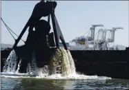  ?? LAURA A. ODA STAFF ARCHIVES ?? Dredges pull buckets of mud from the OaklandAla­meda Estuary in Oakland at the Port of Oakland in 2009.