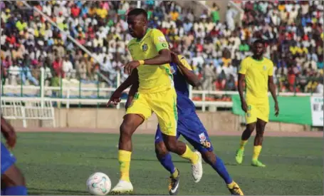  ??  ?? Kano Pillars’ Rabiu Ali (left) is challenged for ball possession by Ubido Julius of Heartland during their opening game of the 2018/2019 NPFL season at the Sani Abacha Stadium in Kano…yesterday. Pillars won 1-0