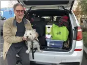  ?? ADAM BEAM — THE ASSOCIATED PRESS ?? Matt Frinzi, 68, poses with his dog, Whitey, and his car filled with his belongings in West Sacramento on Tuesday. Prinzi has lived in California for 25 years. But Tuesday he officially moved to Reno, Nevada. He said his quality of life has deteriorat­ed so much in California that he wanted to leave.