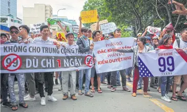  ?? EPA ?? Vietnamese protesters hold a banner reading ‘No leasing land to China even for just one day’ during a rally against a draft law on the Special Economic Zone, at a street in Ho Chi Minh City on June 10.