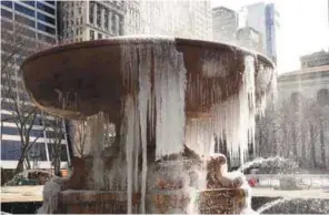  ?? AFPPIX ?? ... The Josephine Shaw Lowell Memorial Fountain in New York’s Bryant Park is covered in ice on Monday. Storm Stella unleashed its fury on much of the northeaste­rn US yesterday, dropping snow and sleet across the region and forcing school closures and...