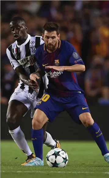  ??  ?? Lionel Messi of Barcelona competes for the ball with Blaise Matuidi of Juventus during their UEFA Champions League Group D match at Camp Nou.