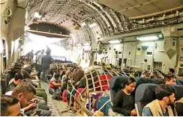  ?? — DC ?? Indians on board an Indian Air Force C-17 aircraft, before landing at Jamnagar in Gujarat on Tuesday. The IAF evacuated Indians and staffers of the Indian Embassy from crisis-hit Afghanista­n on Tuesday.