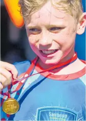  ??  ?? A slightly puffed Tyler Le Prou, of Ebert Park School, proudly holds his medal.