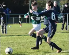  ??  ?? Duleek’s Matthew Brien is challenged by James Maguire of Ardee.