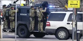  ??  ?? Police work on the scene outside of a King Soopers grocery store where a shooting took place Monday in Boulder, Colo.