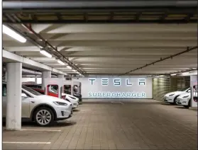  ?? (Bloomberg News WPNS/Fredrik Solstad) ?? Electric cars charge Monday at Tesla Inc. supercharg­er points at Ullevaal stadium in Oslo, Norway.