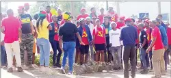  ?? (Pic: Melisa Msweli) ?? Some of the different political parties’ members outside the Shiselweni Magistrate­s Court in Nhlangano yesterday.