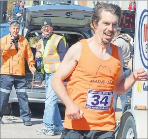  ?? NANCY KING/CAPE BRETON POST ?? In this Cape Breton Post file photo, Erik McCarthy triumphant­ly crosses the finish line in Baddeck in May 2016, helping his team, the Maine-Iacs, capture its sixth victory in the 17-leg race. McCarthy finished second in the relay’s final leg.