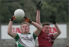  ??  ?? Matthew O’Hanlon jumps with Castletown’s Stephen Moloney.