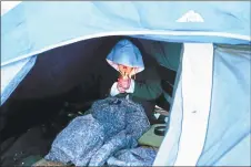  ?? Hearst Connecticu­t Media file photos ?? A woman sits in a tent at a New Haven homeless encampment off Interstate 91 exit 6 before the camp was razed in 2016. Below, and area beneath a highway underpass in New Haven where homeless people camped.