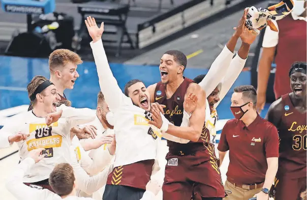  ?? MICHAEL CATERINA/ INDYSTAR ?? Loyola Chicago players celebrate knocking off Illinois in the second round of the men’s NCAA Tournament on Sunday at Bankers Life Fieldhouse in Indianapol­is.