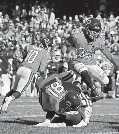  ?? JEFF HAYNES/AP ?? Bears running back David Montgomery (32) runs the ball in for a touchdown in Sunday’s loss to the Chargers at Soldier Field.