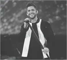  ?? PHOTO BY CHRISTOPHE­R POLK/GETTY IMAGES ?? Thomas Rhett, shown at the 2017 iHeartRadi­o Music Awards, takes the stage in Regina on Monday.