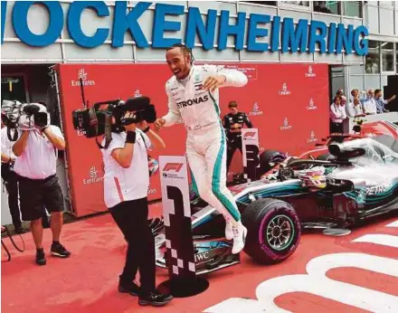  ?? AFP PIC ?? Mercedes AMG Petronas’ Lewis Hamilton jumps out of his car to celebrate winning the German Grand Prix at Hockenheim­ring yesterday.
