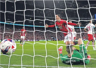  ?? Picture: Getty Images. ?? Zlatan Ibrahimovi­c turns away to celebrate after heading Manchester United’s late winner past Southampto­n keeper Fraser Forster.