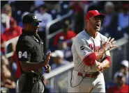  ?? PATRICK SEMANSKY — THE ASSOCIATED PRESS ?? Philadelph­ia Phillies manager Gabe Kapler, right, reacts after Brad Miller was ejected by umpire Alan Porter, left, in the first game of a doublehead­er against the Washington Nationals, Tuesday, in Washington.