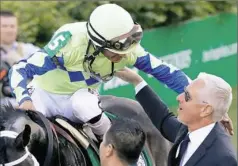  ??  ?? Trainer Todd Pletcher, right, congratula­tes jockey John Velazquez, atop Always Dreaming, after winningthe 2017 Kentucky Derby. The odds say more celebratio­ns are in store for Pletcher this May.