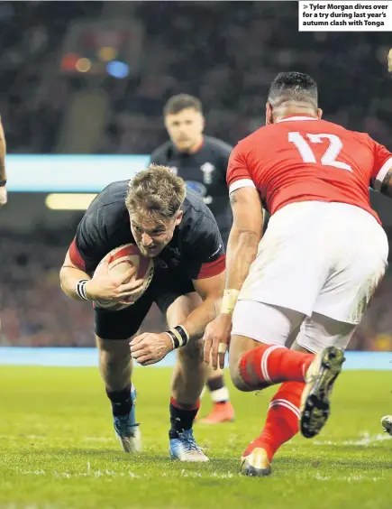  ??  ?? > Tyler Morgan dives over for a try during last year’s autumn clash with Tonga