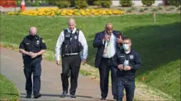  ?? Julio Cortez/Associated Press ?? Police walk near the scene of a shooting Tuesday at a business park in Frederick, Md.