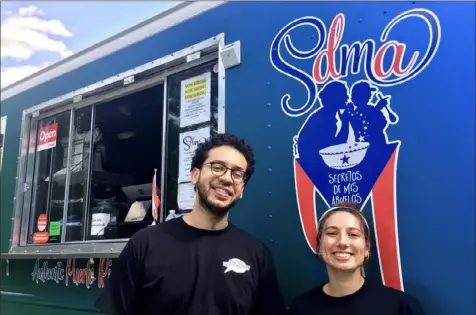  ?? Dan Gigler/Post-Gazette photos ?? Secretos de mis Abuelos food truck owner Felipe Crespo, left, and team member Elizabeth Lusardi with the truck in Beechview in July. The food is now also available at Hapa Hawaiian Grill in Uptown.