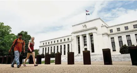  ??  ?? Dollar factor: People walk past the Federal Reserve building in Washington. In the longer term, how fast the Federal Reserve shrinks its US$4.5 trillion balance sheet would impact the dollar. — AP