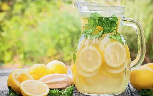  ?? 123RF.COM ?? A large batch of lemonade, garnished with lemons and fruit, is an easy way to welcome guests.