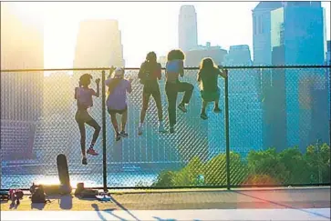  ?? Magnolia Pictures ?? AN INVITATION TO hang out, though maybe not quite so literally, helped lead to the “Skate Kitchen” movie. On the fence are, from left, Kabrina Adams, Nina Moran, Ajani Russell, Brenn Lorenzo and Rachelle Vinberg.