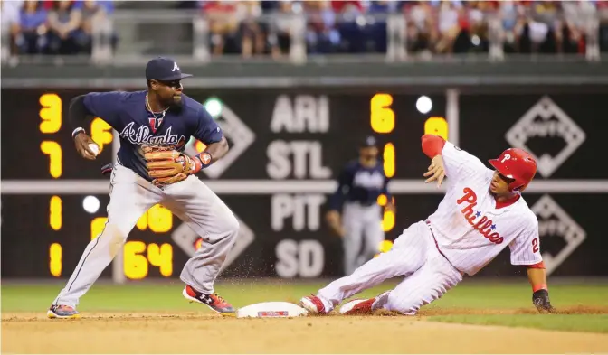  ??  ?? PHILADELPH­IA: Aaron Altherr #23 of the Philadelph­ia Phillies is forced out at second base as Brandon Phillips #4 of the Atlanta Braves turns a double play in the eighth inning during a game at Citizens Bank Park on Saturday in Philadelph­ia,...