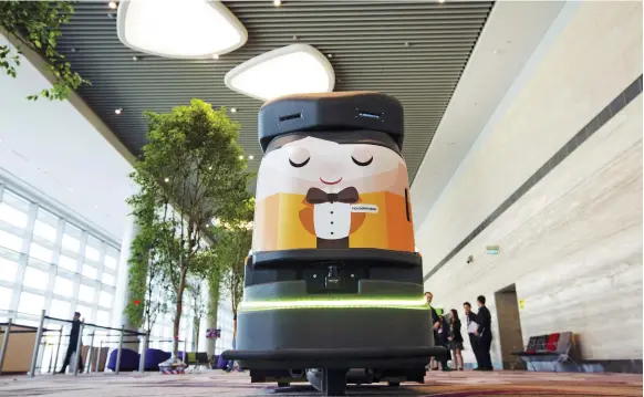  ?? Bloomberg ?? Only through human ability can inventions such as this automated robotic cleaner at Changi Airport in Singapore become a reality