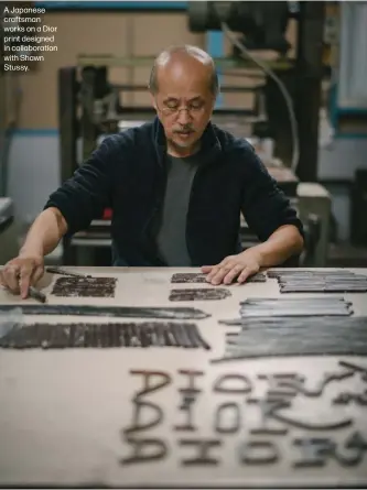  ??  ?? A Japanese craftsman works on a Dior print designed in collaborat­ion with Shawn Stussy.