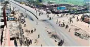  ??  ?? People walk on a street empty of vehicles during the countrywid­e transport strike in Dhaka.