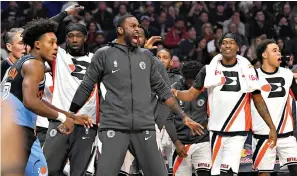  ?? AP Photo/Mark J. Terrill, File ?? ■ Los Angeles Clippers players celebrate from the bench as Cleveland Cavaliers guard Collin Sexton, left, walks away during the second half Jan. 14 in Los Angeles. At the NBA restart, where the only fans inside the building are the ones wearing uniforms, enthusiasm from players on the bench is most definitely getting noticed.