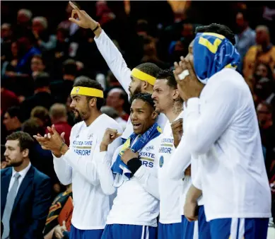  ??  ?? Round Three of Warriors-Cavs in the NBA Finals was largely one-sided. Left, Finals MVP Kevin Durant rises over LeBron James for a shot. Above, the Warriors' role players cheer the final moments of a Game 3 win. Following, James stares down Golden...