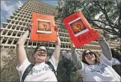  ??  ?? THE office is “grossly under-resourced,” the ACLU report says. Above, deputy public defenders protest.