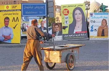  ?? AFP ?? An Iraqi Kurdish man walks past an election campaign poster in Arbil, the capital of the northern Iraqi Kurdish autonomous region, last week.