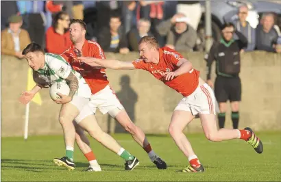  ??  ?? Ryan Ward and Alan Landy of Hunterstow­n Rovers attempt to tackle Ryan Sheridan of St. Fechin’s during the Group D IFC game in Stabannon.