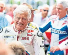  ?? ?? Two legends, 15-times World Champion Giacomo Agostini and behind him Mick Doohan. [Photo by Lou Johnson]