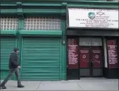  ?? MARY ALTAFFER — THE ASSOCIATED PRESS ?? A pedestrian walks past the world headquarte­rs of the Israelite Church of God in Jesus Christ on Thursday in the Harlem neighborho­od of New York.