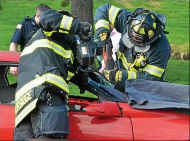  ?? JOHN BREWER — ONEIDA DAILY DISPATCH ?? Oneida High School students, along with the Oneida Police Department, Oneida Fire Department, Vineall Ambulance, Madison County District Attorney, and Campbell-Dean Funeral Home, take part in a mock DWI accident at the Oneida High School on Thursday.