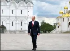  ?? ALEXEI DRUZHININ — SPUTNIK, KREMLIN POOL PHOTO VIA AP ?? Russian President Vladimir Putin walks along the Cathedral Square of the Kremlin, to take part in a holiday reception in Moscow, Monday. Since 1992 the ‘Day of Russia’ is annually celebrated on 12 June as the Russian Federation’s national holiday.