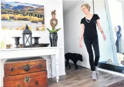  ??  ?? Eve follows Julie Brown through the entrance. The painting is by Sue Currie. The old camphor chests store spare hats and gloves.